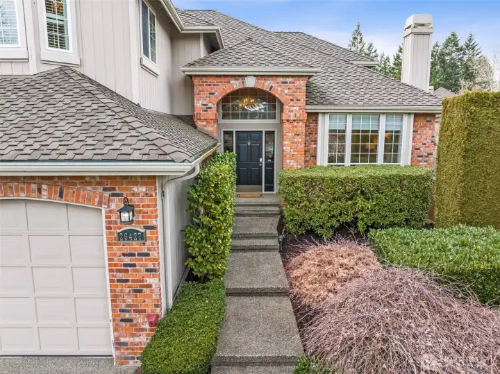 Steps lead up to the front door, and to the right there is a camelia hedge with 3 different STUNNING colors that will be in bloom in April! There are hidden suprises for the Spring throughout this yard!