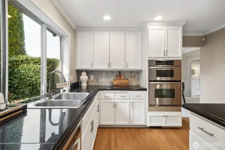 Here we are in the kitchen. Combo microwave and oven, granite countertops, hardwood floors and lots of counterspace.