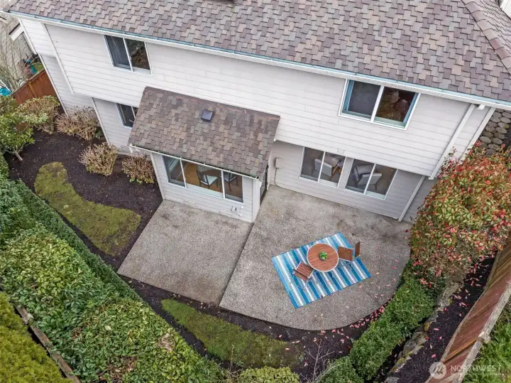 Drone view of the private backyard. Lots of mature shrubs that can be cut back or removed for more yard space.