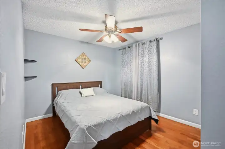 Another view of the second bedroom, highlighting the clean lines and closet space to the right.