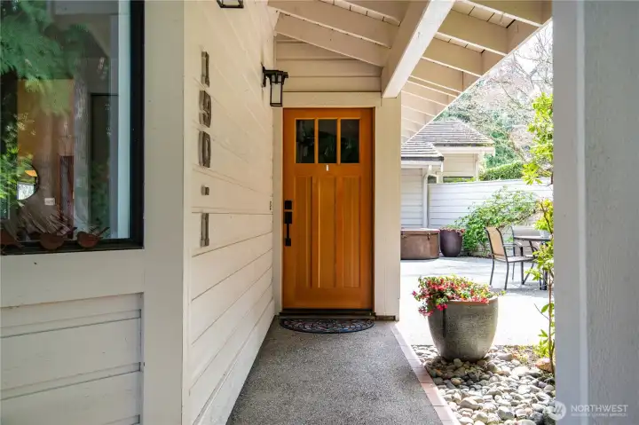 The approach to the front door is covered, providing protection from the elements any time of year. Let's go inside!