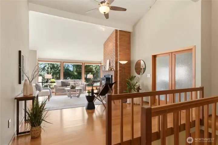 Continuing our tour on the main floor, the lovely barn doors with obscure glass lead us to the main level primary suite.