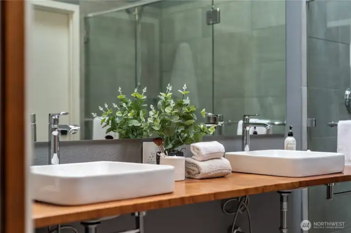 The primary suite vanity countertop is custom made from black walnut. It's a beautiful centerpiece of this room.