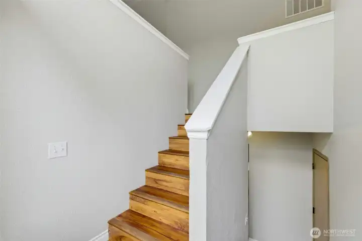Beautiful wood staircase and soaring ceilings create a bright, welcoming entry Beautiful wood staircase and soaring ceilings create a bright, welcoming entry