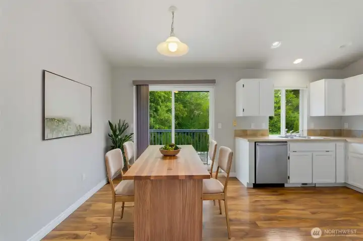 Enjoy meals with a view in this light-filled dining space, perfectly positioned beside the kitchen and featuring sliding glass door access to the deck, where peaceful greenbelt views create a relaxing backdrop for everyday dining and entertaining Enjoy meals with a view in this light-filled dining space, perfectly positioned beside the kitchen and featuring sliding glass door access to the deck, where peaceful greenbelt views create a relaxing backdrop for everyday dining and entertaining