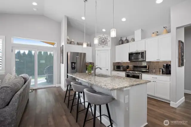 Kitchen and living lead right to covered patio