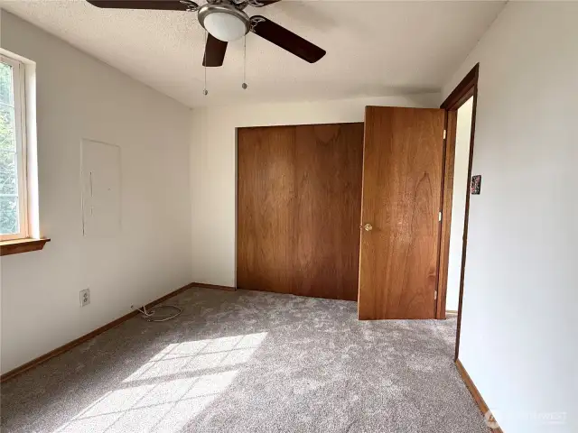 Front bedroom with lots of closet space and ceiling fan