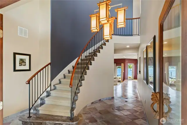 Grand staircase and custom woodwork greet you--along with those beautiful views of Miller Bay!