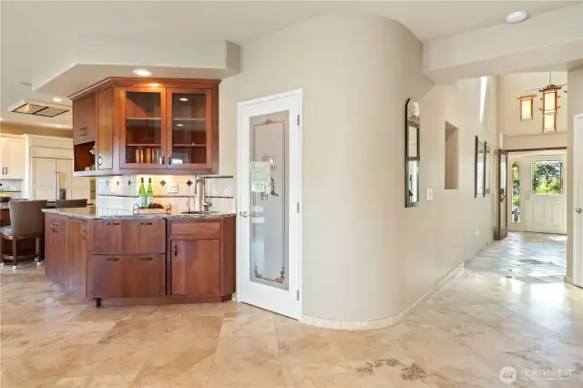 Wet bar with pull-out refrigerator and freezer to the left of the sink.