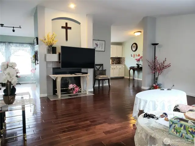 A Spectacular View of the Living Room greets you as you walk in from the Front Door to This Beautiful Home Showing Hard Wood Flooring, Newer Paint and Real Wood Fireplace.