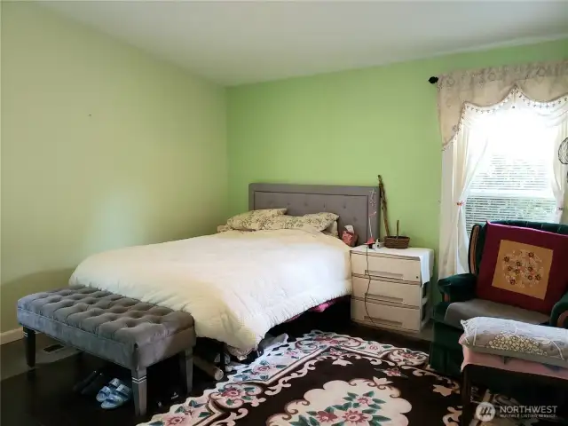 Spacious Primary Master Bedroom Showing Hard Wood Flooring Showing Room for King Sized Bed and Room for Dressers.