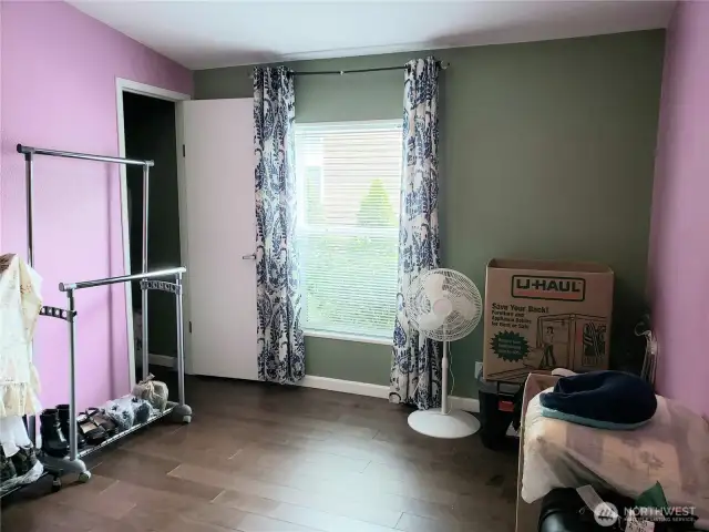 Another Picture of the A good Sized Third Bedroom with Hard Wood Flooring and Trim Showing the Walk In Closet.