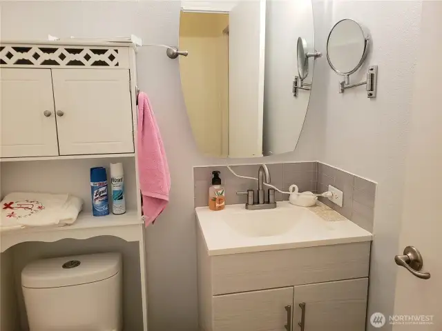 A very Nice Main Guest Bath Room with Tile Floor, Newer Paint, New Vanity, Faucet and Toilet.