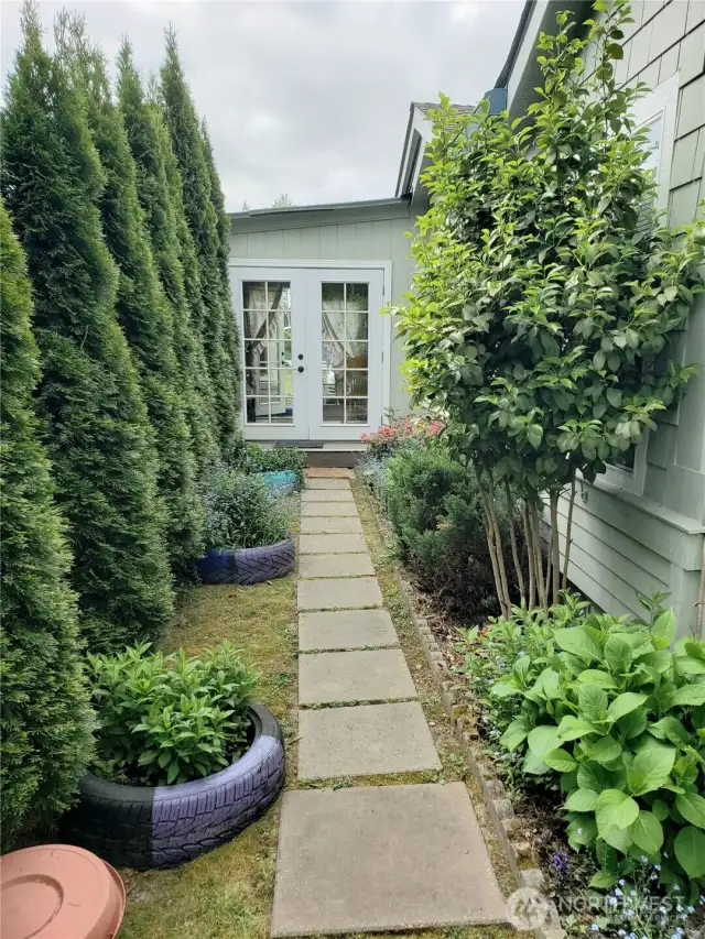 Side View of the Home Showing Stepping Stone Walk Way to the Covered Porch Front Room Entry.