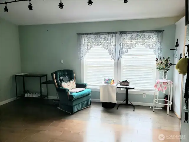 A View of the Spacious Dining Room from the Living Room Area with Hard Wood Flooring and Newer Paint.