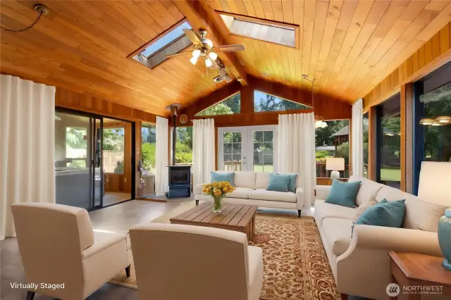 Large recreation room with pellet stove. Picture displays virtual staging.