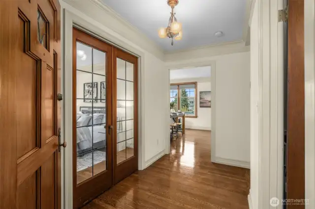 Beautiful Hardwood floors, Leaded Glass Doors and Original Antique Light Fixtures greet you upon Entry to the Unit.