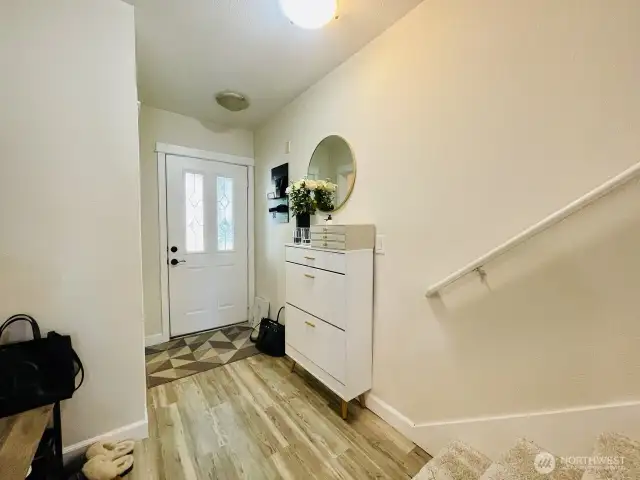 Entrance, headed out to front porch, passing kitchen & main floor bedroom, heading out to garage.
