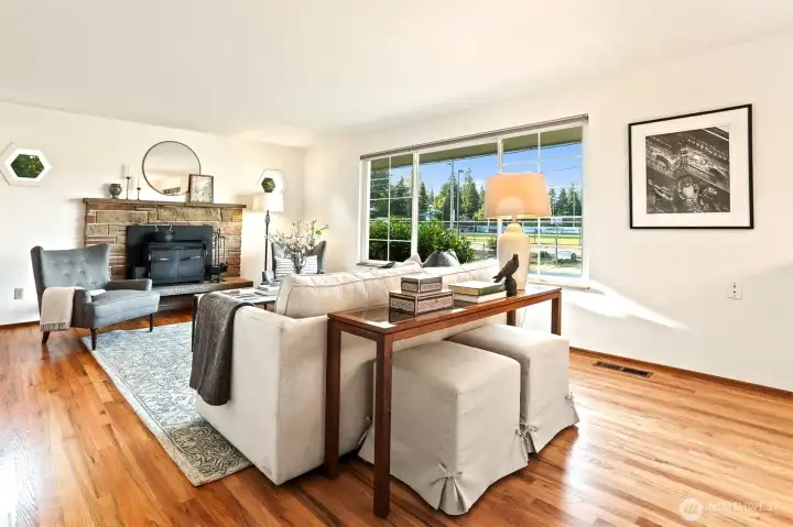 Living room with freshly refinished hardwoods throughout  main! Wood burning fireplace