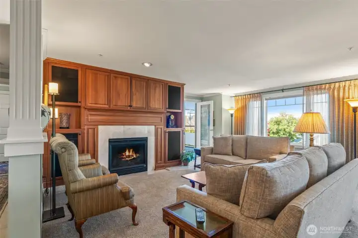 Living room with custom details and fireplace.