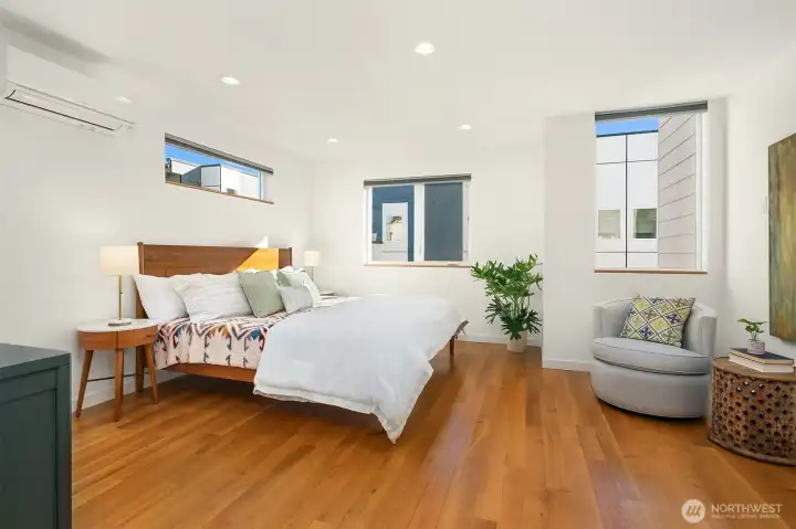 Huge primary bedroom with walk-in closet and modern bathroom.