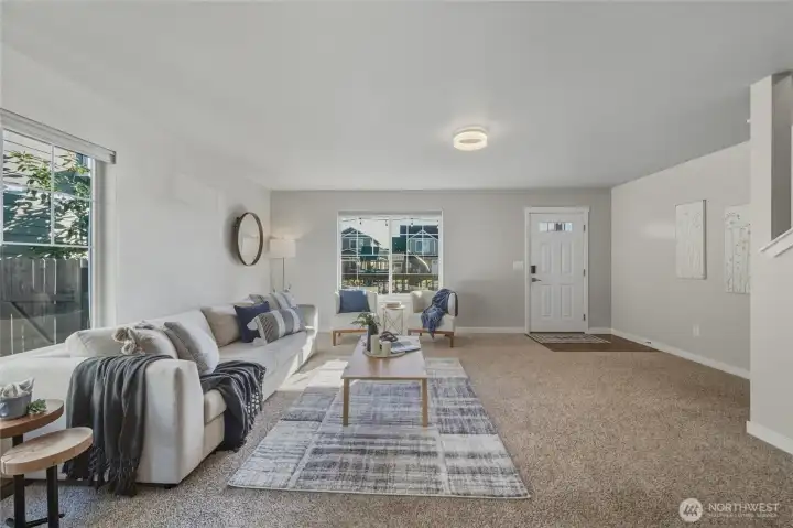Step into a warm, welcoming main level with fresh interior paint and wide open living space. The layout offers flexibility, comfort, and charm, with easy access to the upstairs, kitchen, and outdoor areas.