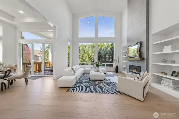 Living room with two-story high ceiling and huge windows: maximizing natural light.