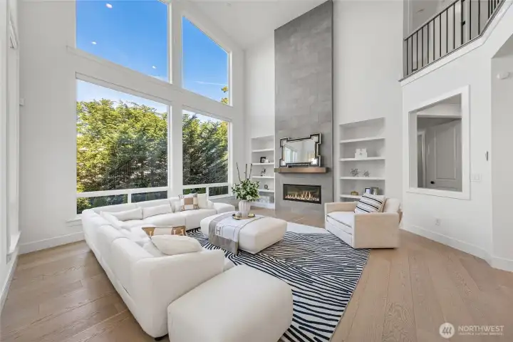 Gas fireplace with beautiful floor-to-ceiling tile surround and built-in shelves.