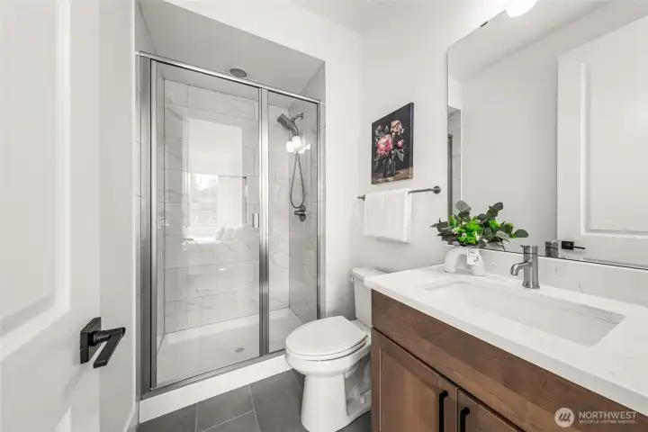 Private bath off the 2nd guest suite on upper level.