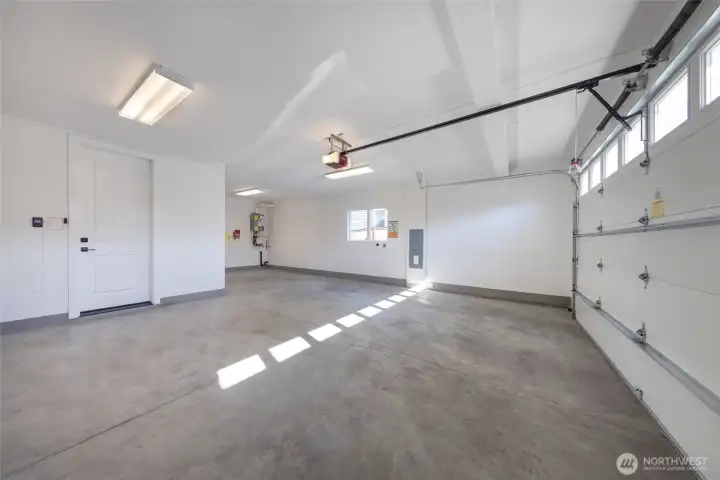 Two-car attached garage with extra storage space and EV charging outlet.