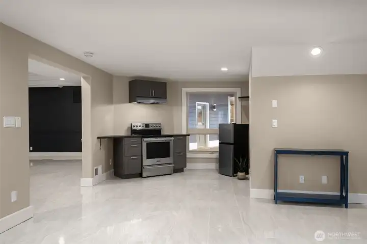 Convenient lower-level kitchenette with cabinetry and prep space.