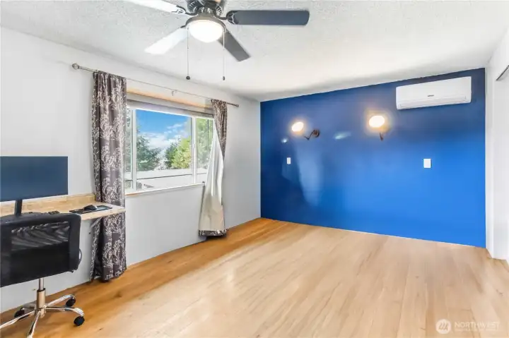 Primary bedroom with mini-split, built in desk, new flooring & connected private bathroom.