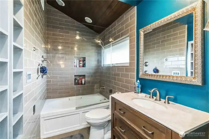 Primary bathroom with tile shower, floors & built ins.
