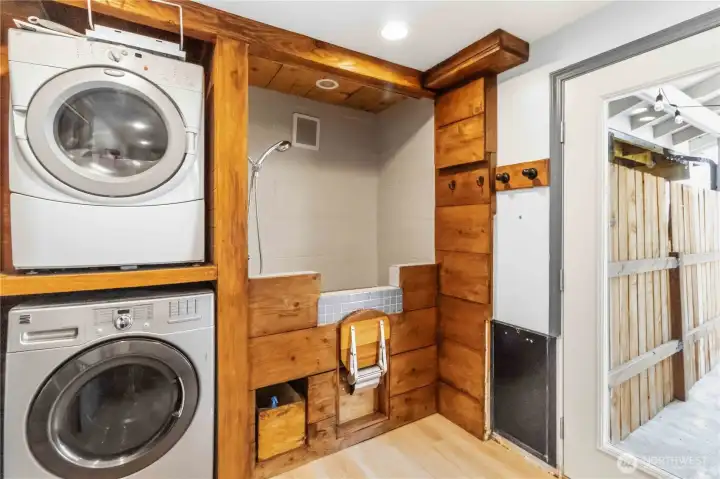 Downstairs utility room with washer/dryer, dog wash station, doggie door to the approx. 2000 sq. ft. fully fenced dog run & access to the hot tub patio.