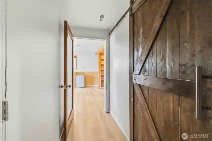 Hall to downstairs bedroom, linen closet is behind the new barn style door.