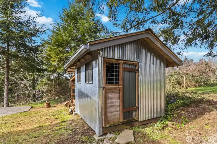 Back yard shed for storage w/ covered lean-to for firewood.