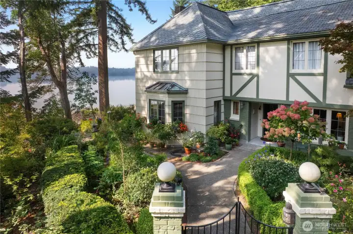 The home’s classic architecture and garden approach are beautifully framed by water views and mature landscape design.