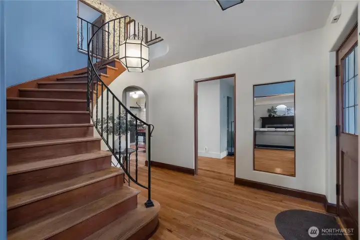 The foyer makes a memorable first impression with classic architectural lines, graceful curves, rich woodwork, and exceptional condition throughout.