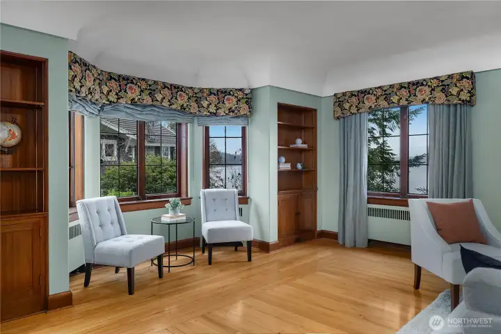 This inviting sitting area captures both the architectural charm of the era and serene views of Eld Inlet.