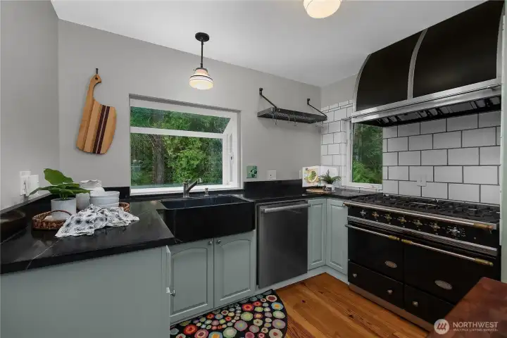 Custom cabinetry, the French La Canche range, the double Subzero ref., Miele DW, soapstone apron-front sink and counters reflect a kitchen renovation rooted in both quality and character.