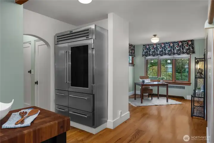 The oversized refrigerator and adjoining workspace add everyday practicality while preserving the home’s timeless appeal.