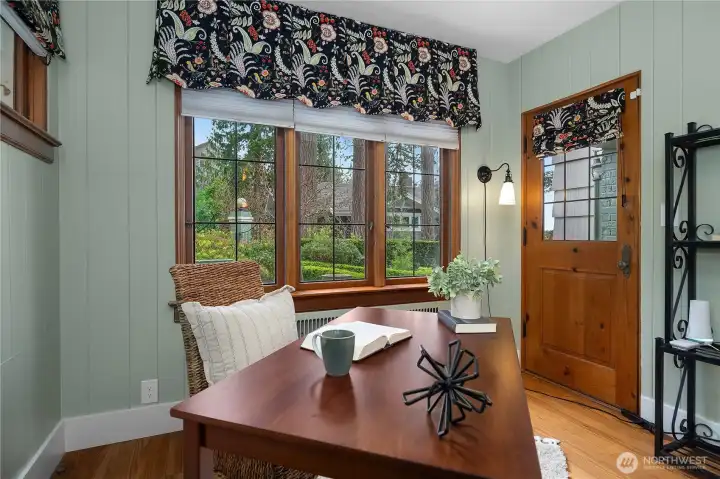 A cozy workspace framed by classic windows and original trim adds charm and versatility to the home.