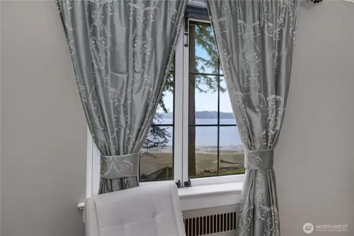 PBR - A window seat with views of Eld Inlet brings a quiet waterfront connection to the primary bedroom.