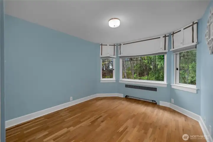 BR 3 - Soft blue tones, generous windows, and classic trim create a bright and welcoming bedroom filled with natural light.