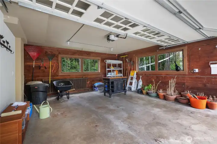 Heated Attached Garage - garage space offers excellent storage, potting, and project area with a warm wood interior and practical layout.
