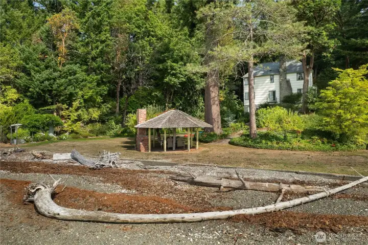 From the water, the setting reveals the privacy, presence, and rarity of this high-end Cooper Point waterfront home.