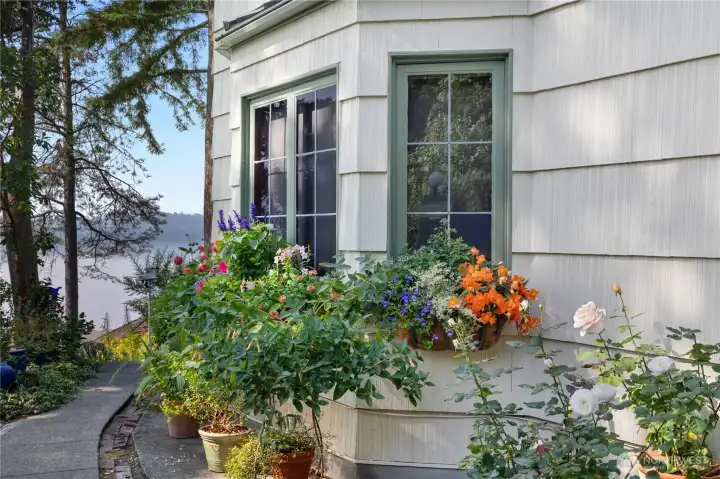 Colorful gardens and curated outdoor spaces reflect the relaxed elegance found throughout this special property.