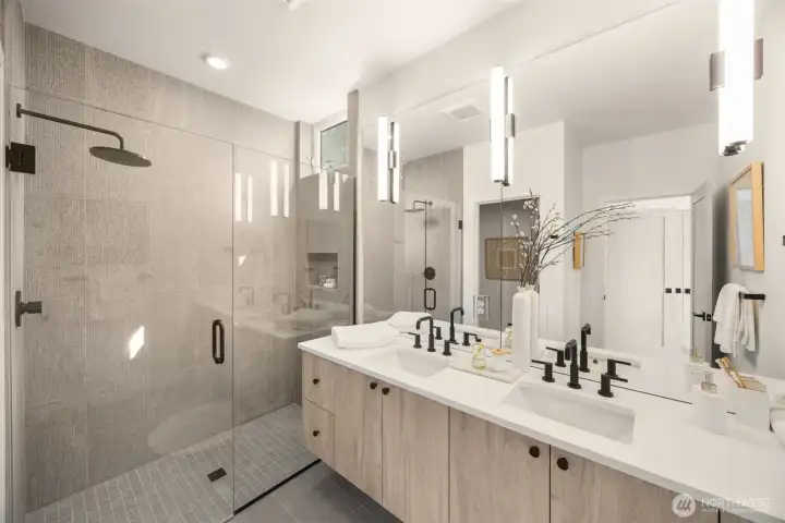 The en-suite bath is a curated retreat with floor-to-ceiling tile and spa finishes.