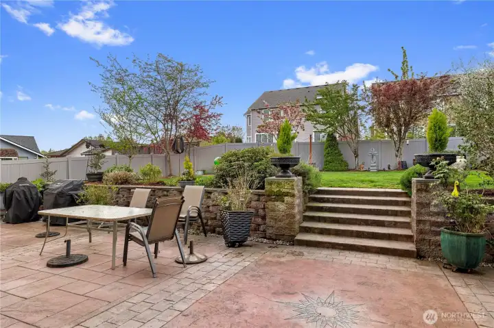 Stamped concrete patio and an electric awning- an ideal setting for outdoor relaxation and a true gardener’s dream.