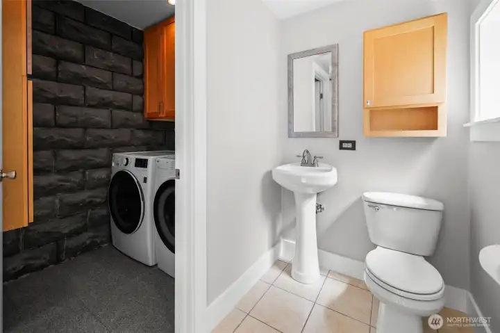 Main floor powder and utility room with storage.
